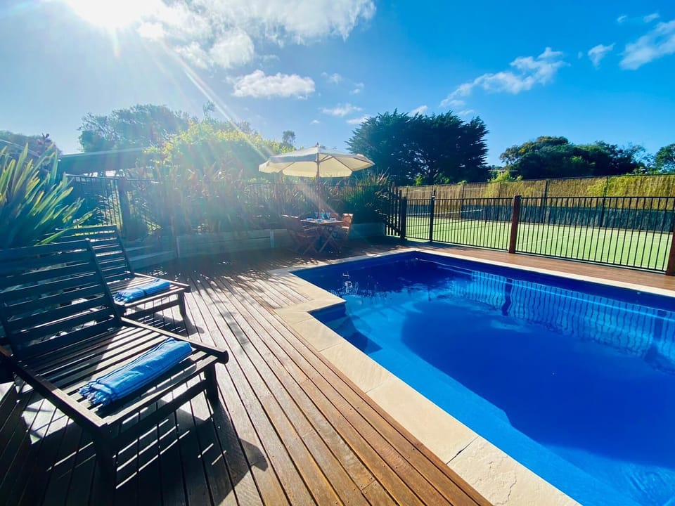 Enjoy lazy afternoons poolside, overlooking the tennis court 
