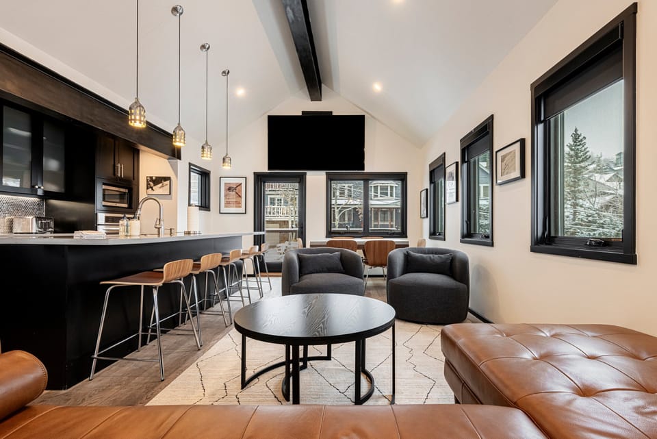 Living Room with small sectional sofa, large smart tv, and private balcony access