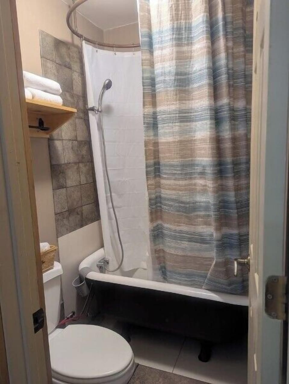BATHROOM:  Includes a tub, shower, and toilet.  Note that there is no sink, vanity, nor mirror in the bathroom.