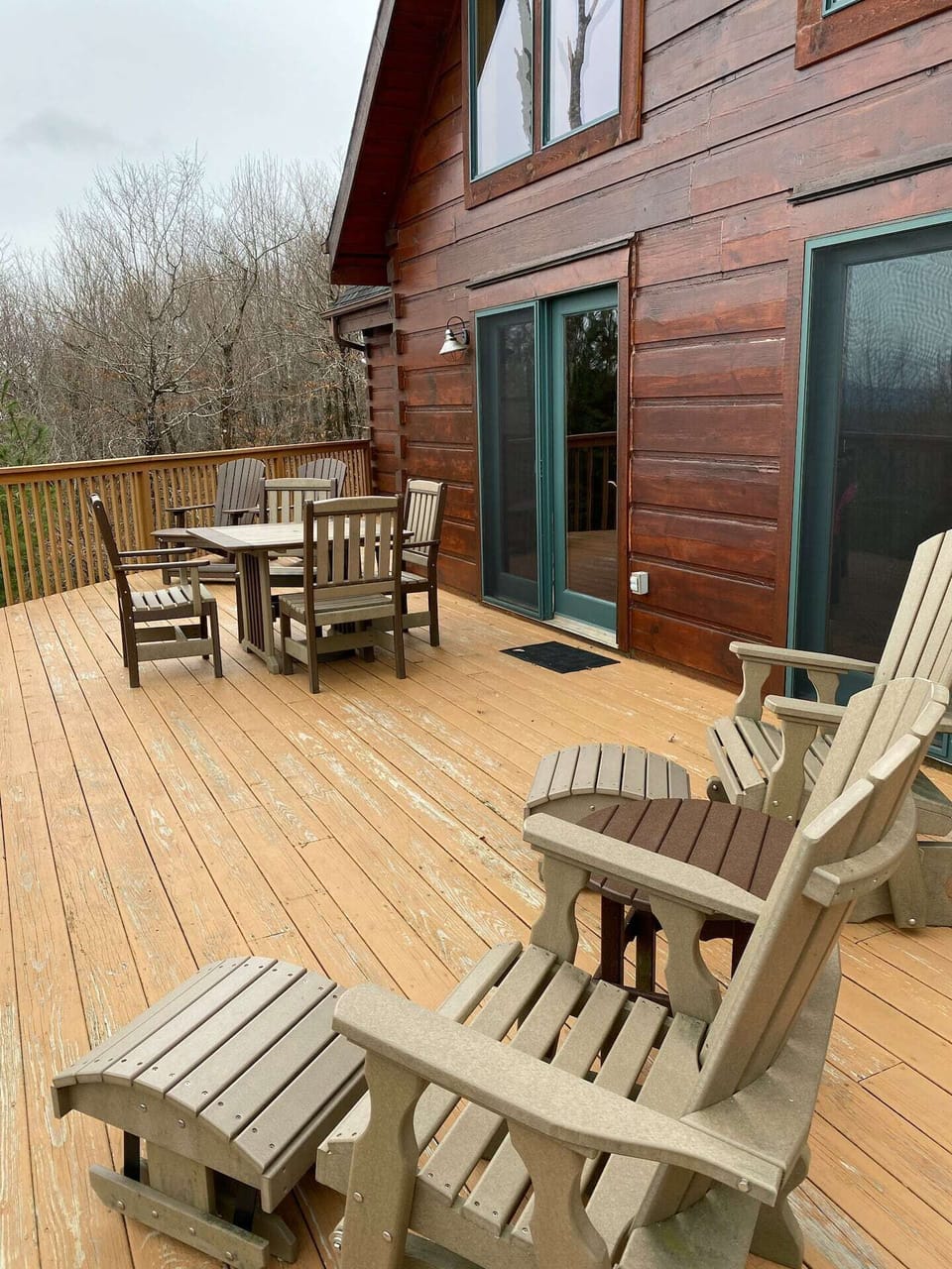 Expansive deck has plenty of comfortable seating, table, and grill.