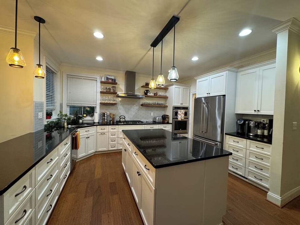 Fully stocked kitchen with cooking and baking utensils, spices, coffee makers