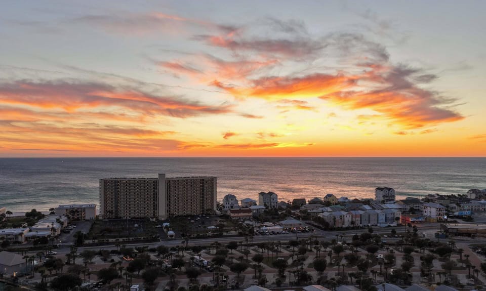The Gulf Coast lights up in orange and pink — another perfect Panama City Beach sunset from The Commodore.