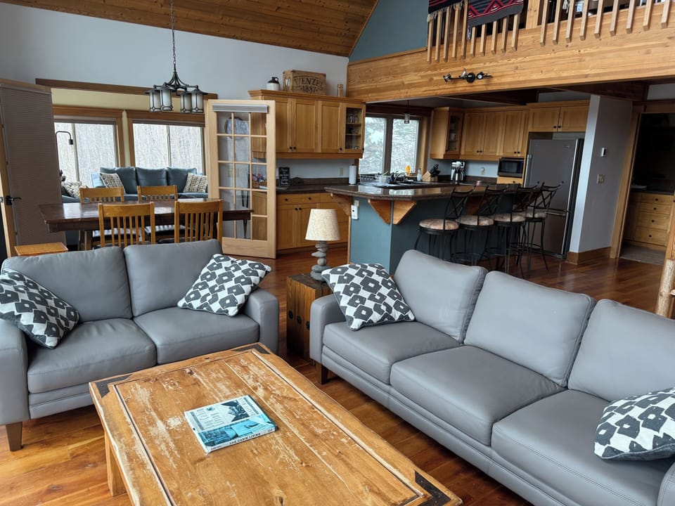 Living room with view of sunroom and kitchen