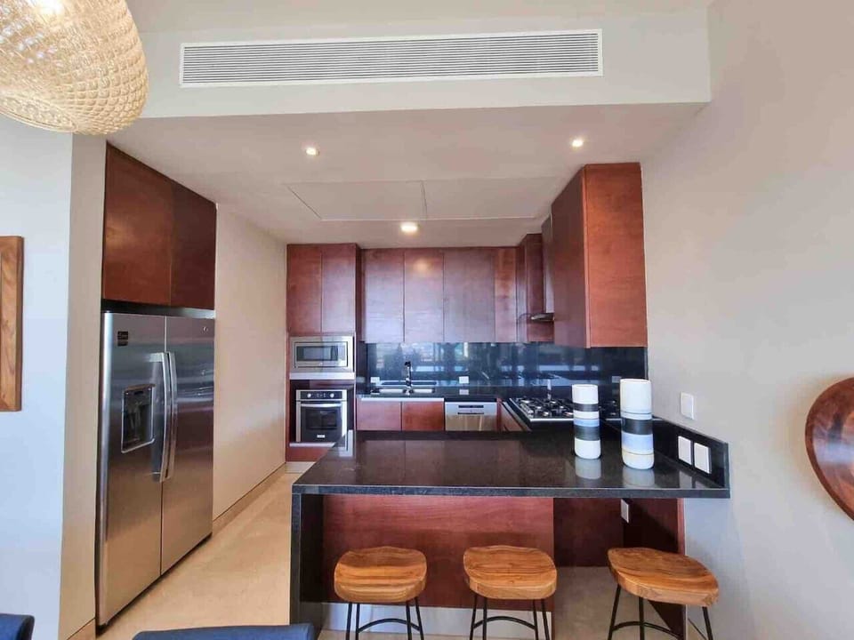Fully equipped kitchen with modern appliances and a spacious breakfast bar.