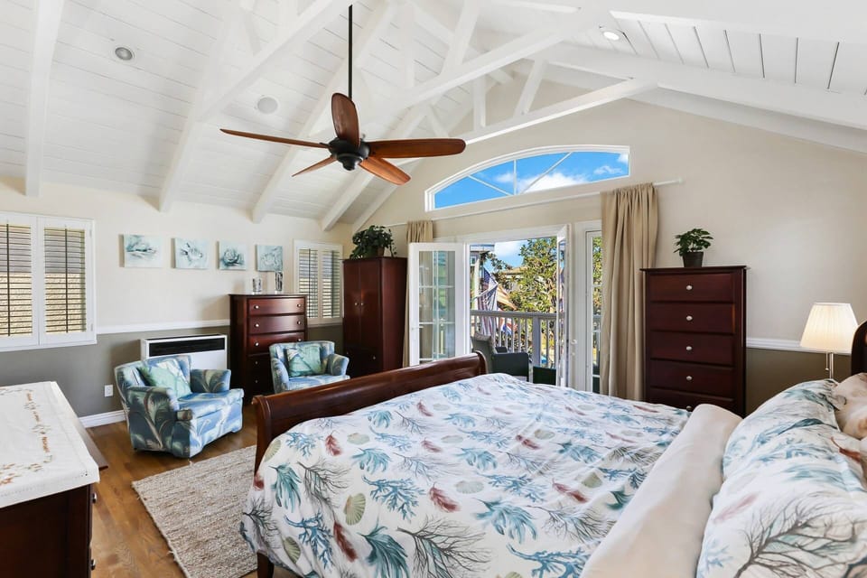 The master bedroom is one of our favorites with the soaring ceilings and the balcony.