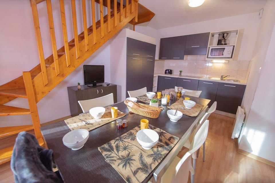 Reconnect with loved ones over a meal at the dining table. Please note that the TV is available for an additional charge.