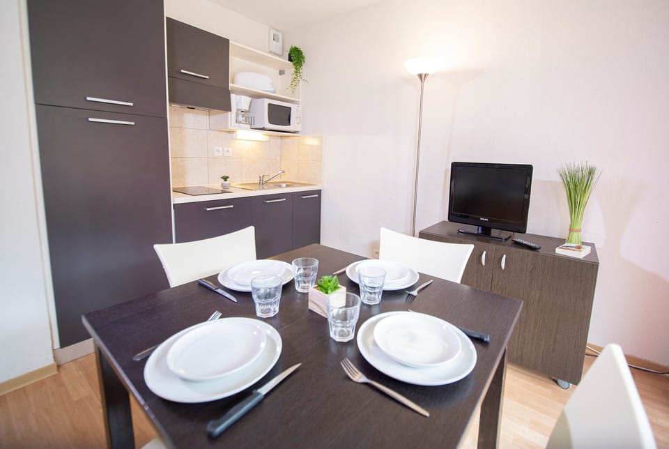 Enjoy a tasty meal at the dining table. Please note that the TV is available for an additional charge.
