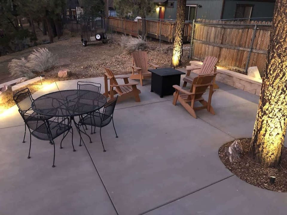 View of backyard with seating and hot tub.