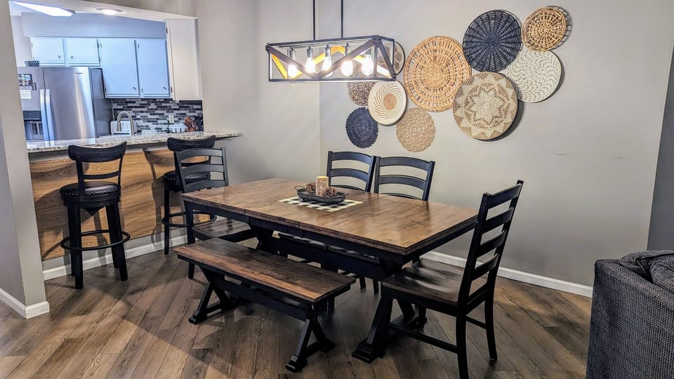 Dining area with seating for 6 at the table and 2 seats at bar