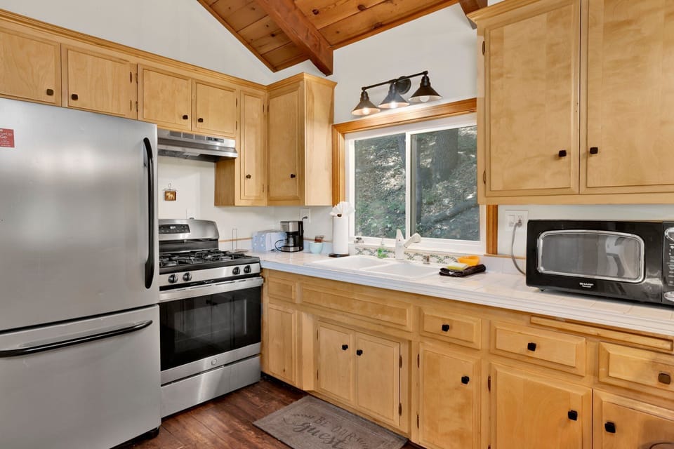 Bright kitchen featuring sleek finishes, generous layout, and warm ambiance for shared meals and gatherings.