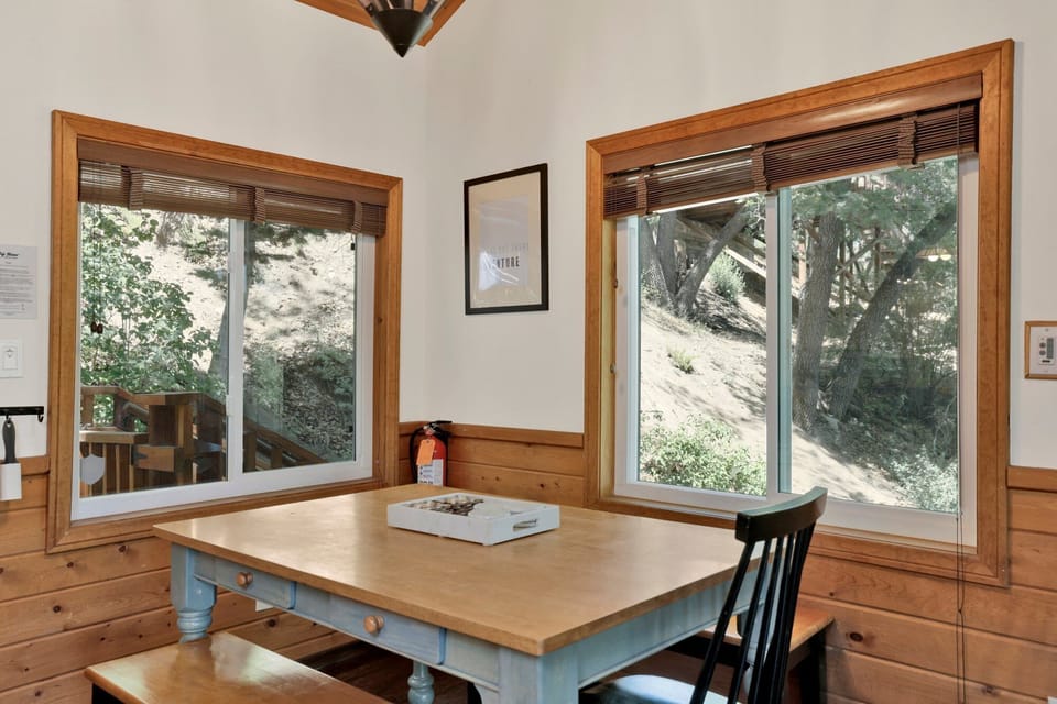 Cozy corner with seating designed for morning coffee, offering serene outdoor views and a peaceful guest experience