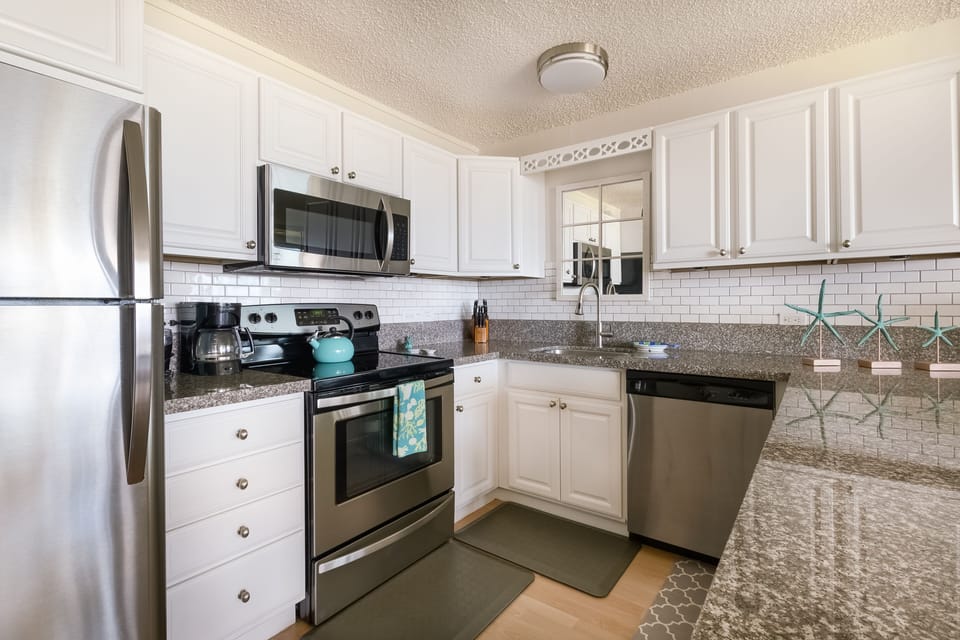 Fully appointed kitchen with chefs knife set and spice rack.