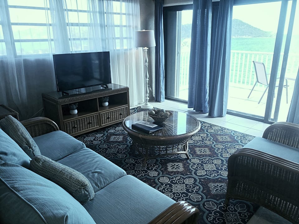 Living area with sliding doors allows you to let the Caribbean b