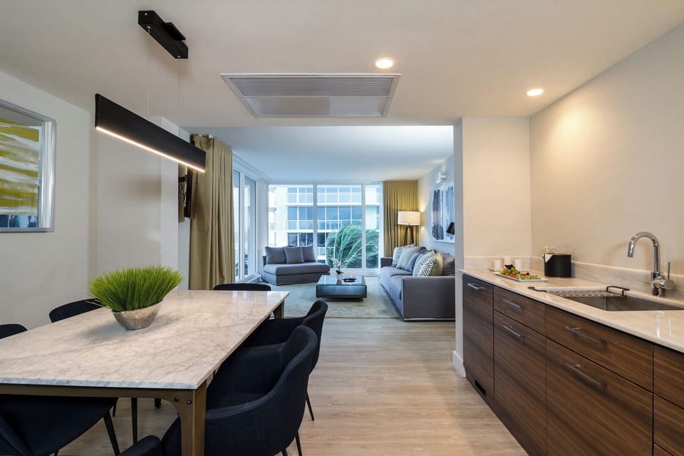 Gather for meals in a sleek, open-plan suite layout.