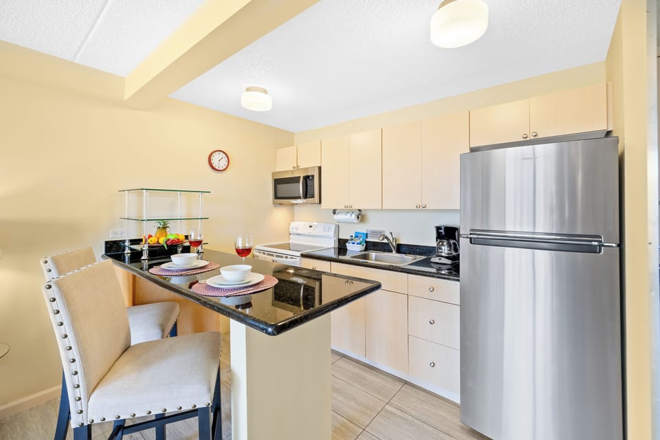 Prepare your meals with convenience in this fully-equipped kitchen—from a full-sized refrigerator, stovetop, microwave, and other appliances you need for daily cooking. The countertop and bar stools also offers a great area for quick meals and coffee.