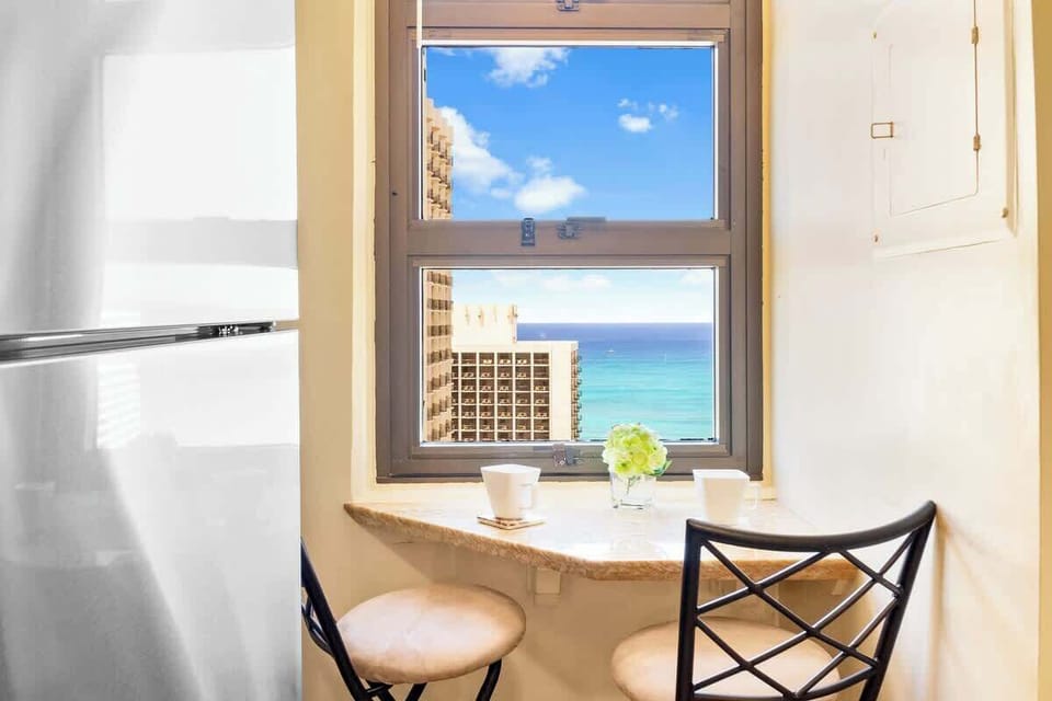 There are 2 extra chairs and a small counter next to the fridge. Have a nice view of the ocean while you are at the kitchen!