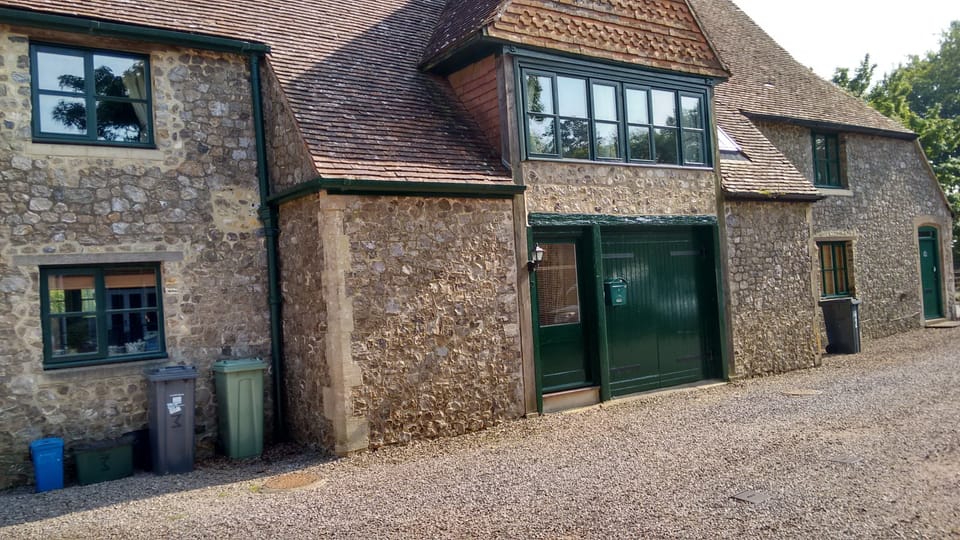 Parking for 1 car is directly in front of the green garage doors 