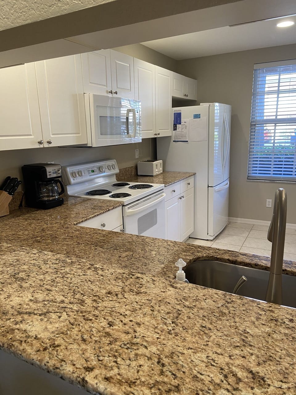 Large kitchen with granite counter tops, French oor refrigerator and pantry.
