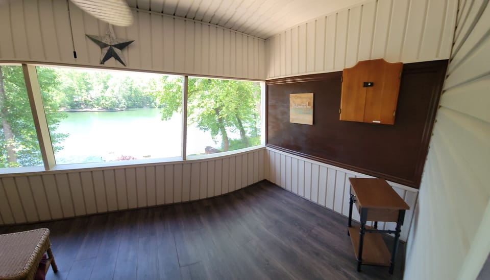 Adults only Screen room with darts and ceiling fan connects to the Lake room