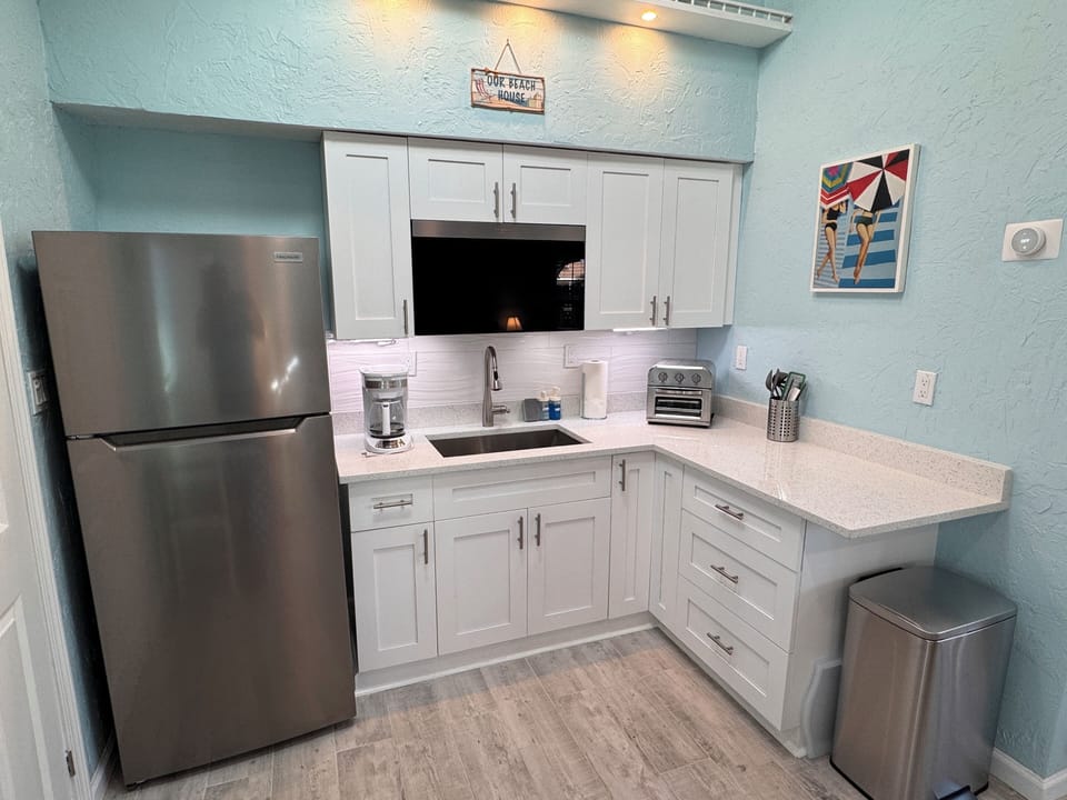 Ample lighting, new cabinets, and quartz tops.  Plenty of kitchen storage