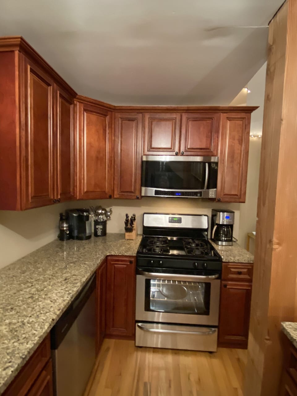 Cabinets filled w/ cooking gear, spices, etc.  Plates, glasses, flatware for 20+