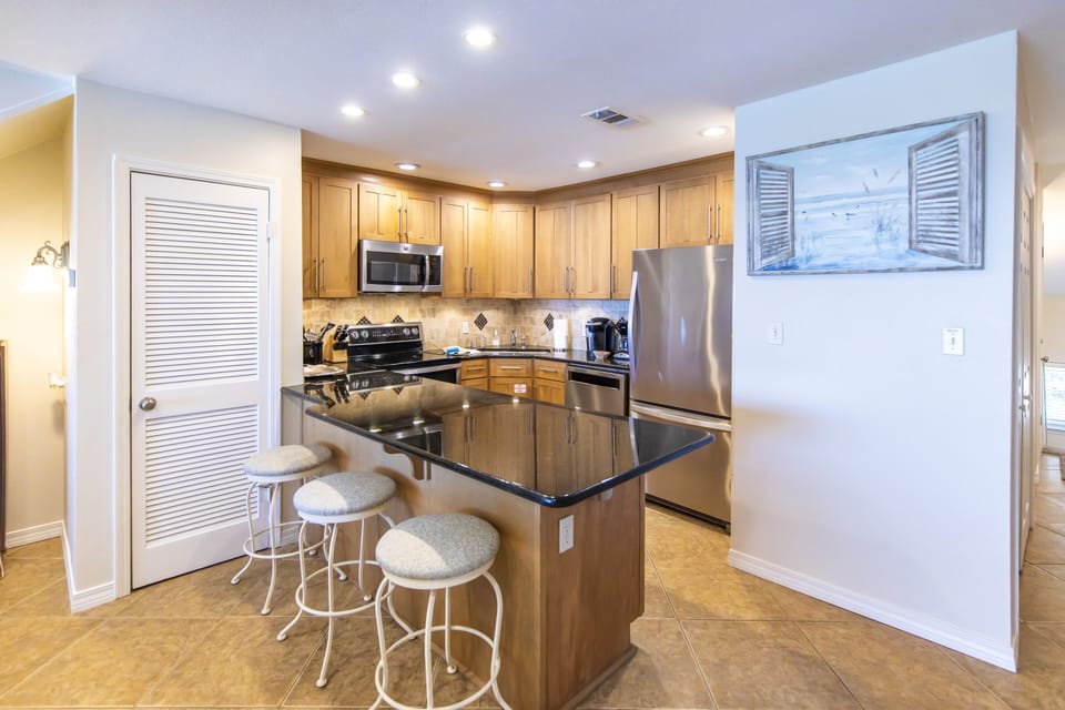 Kitchen with additional bar seating for 3.