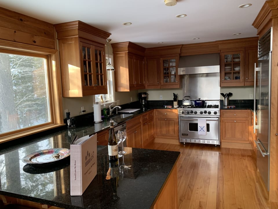 Custom kitchen with cherry cabinets, Subzero refrigerator & wine fridge.