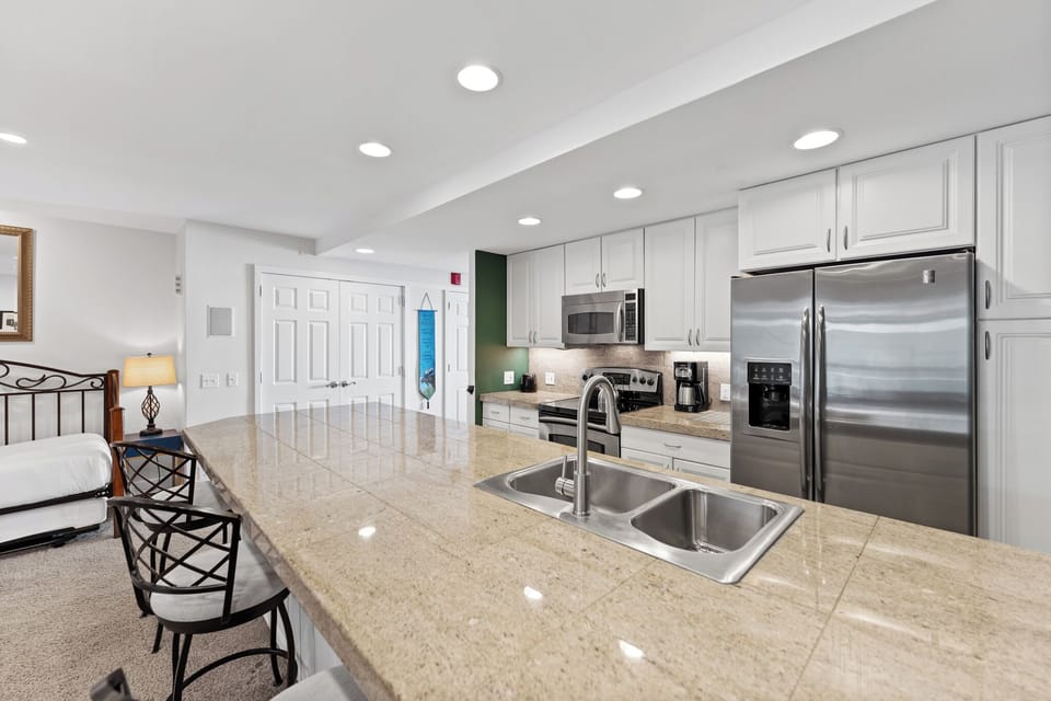 Your spacious kitchen features granite countertops, stainless steel appliances, and seamless flow to your comfortable living area for memorable meal prep.