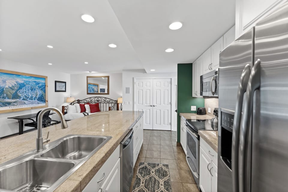 Cook your favorite meals in this fully equipped kitchen with granite counters, stainless steel appliances, and everything you need for a comfortable stay.