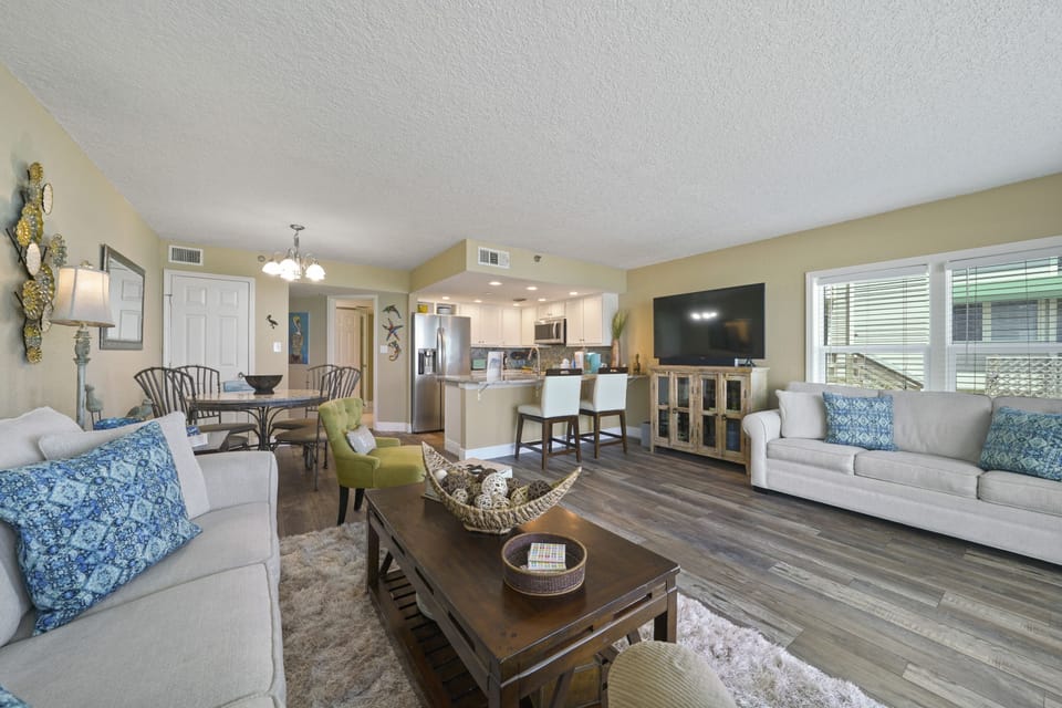 This airy, open concept living room offers direct balcony access with unobstructed ocean views.