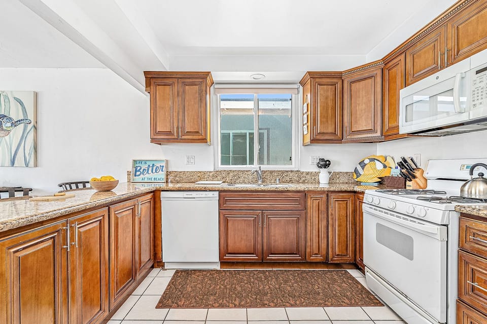 The roomy kitchen comes stocked with dishes, utensils, cookware, bakeware, and all major and small appliances.
                