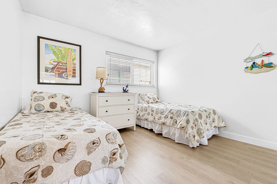 The third guest bedroom includes two twin beds.
                