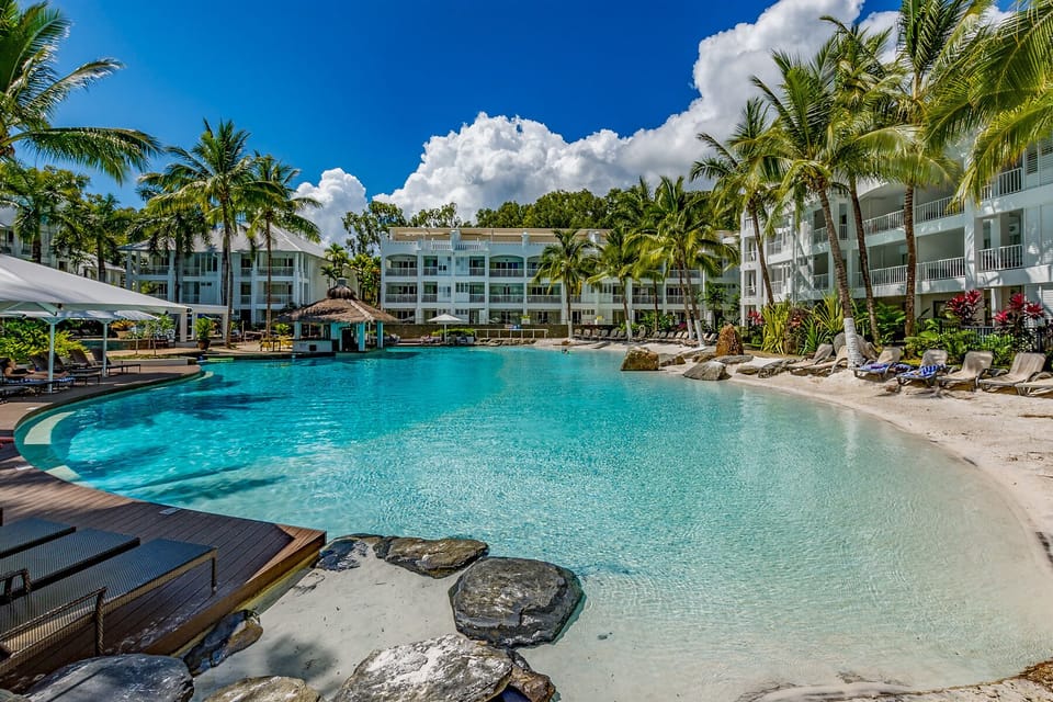 Resort Pool with Sandy Shores and Swim Up Bar