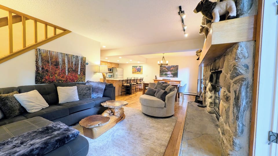 Living room looking into DR and kitchen with wood burning fireplace