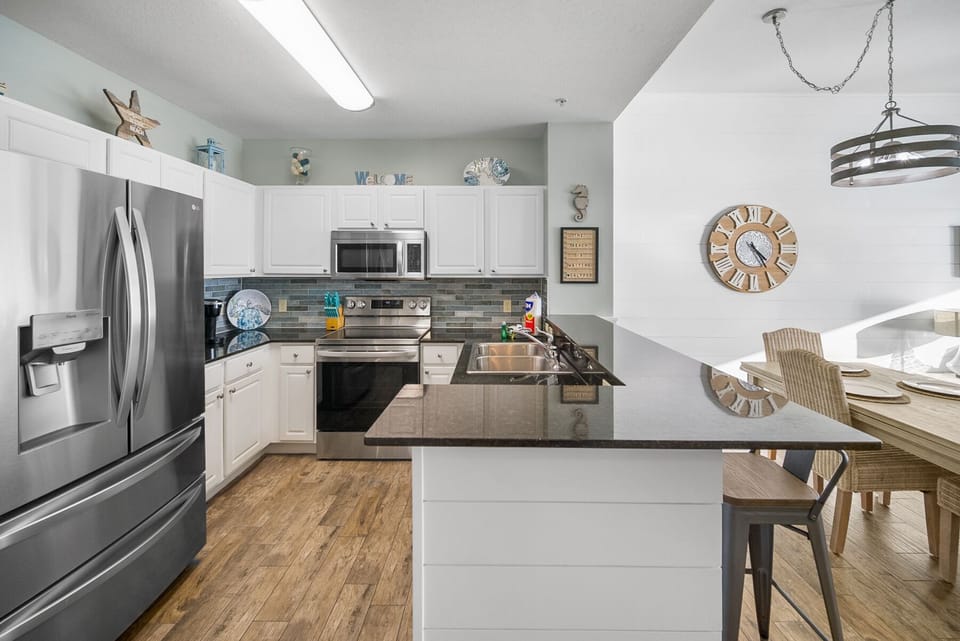 Your fully equipped kitchen awaits with sleek granite countertops, modern appliances, and a spacious island perfect for cooking memorable meals together.