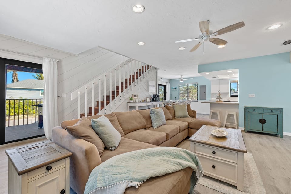 Spacious living area with open floor plan and large TV