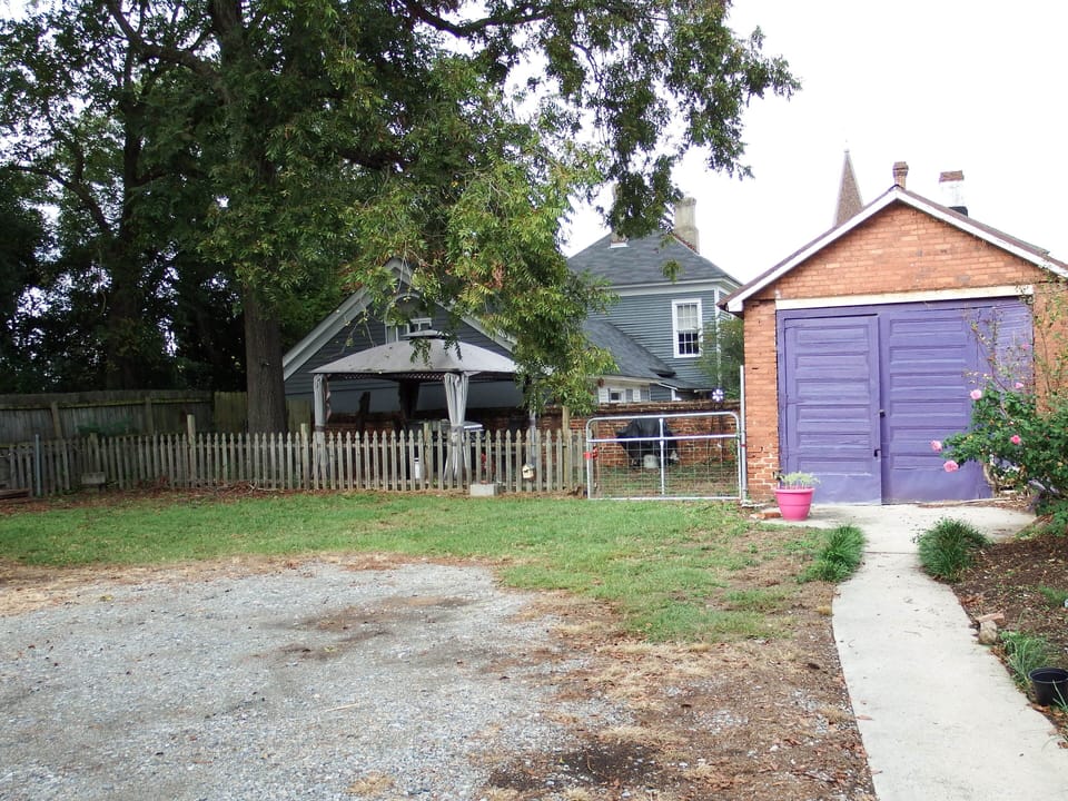 View of shared backyard/rear parking area.