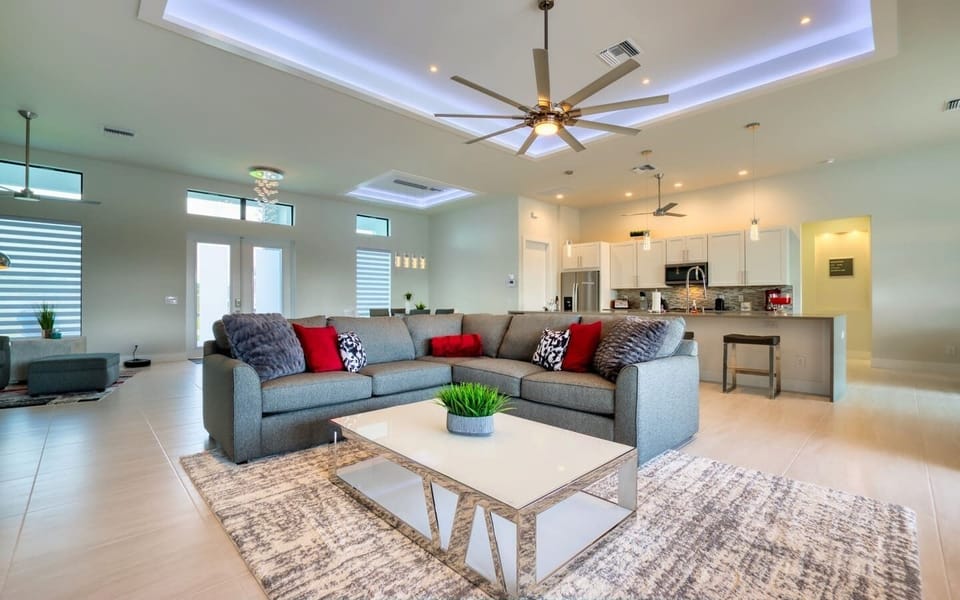 Open-concept great room showing the living area, dining space, and kitchen all connected in an airy layout