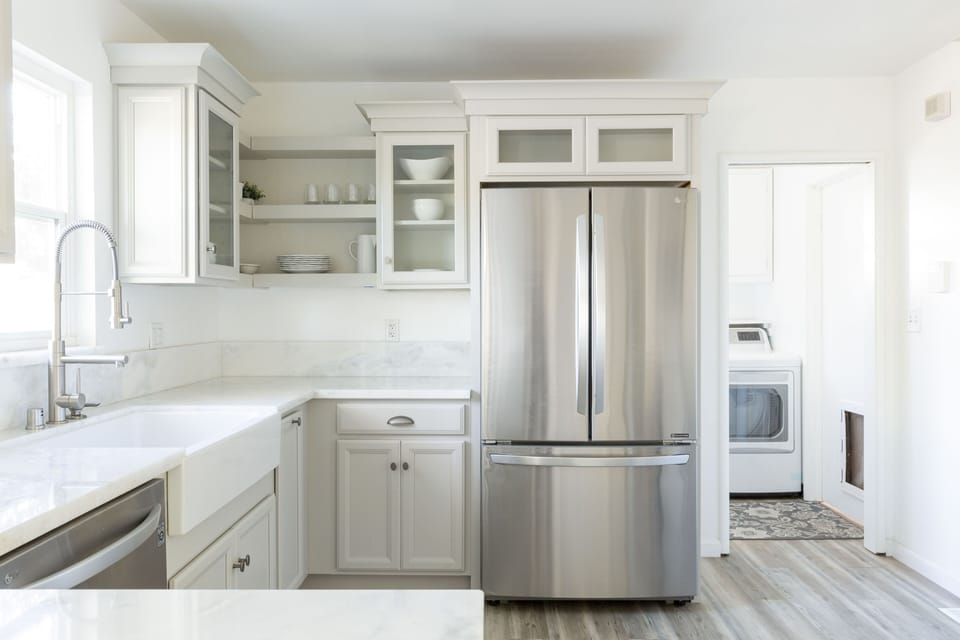 The heart of the home: LG refrigerator, farm sink, pulldown faucet, W/D.