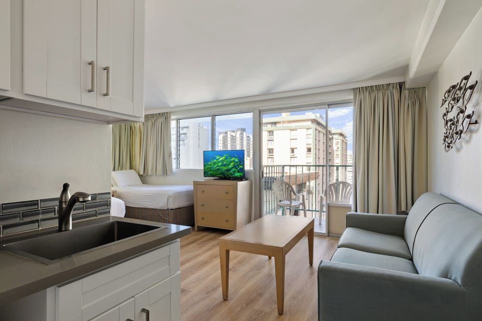 Unwind in your stylish studio with modern kitchen, comfy living space, and sunny balcony overlooking the city.