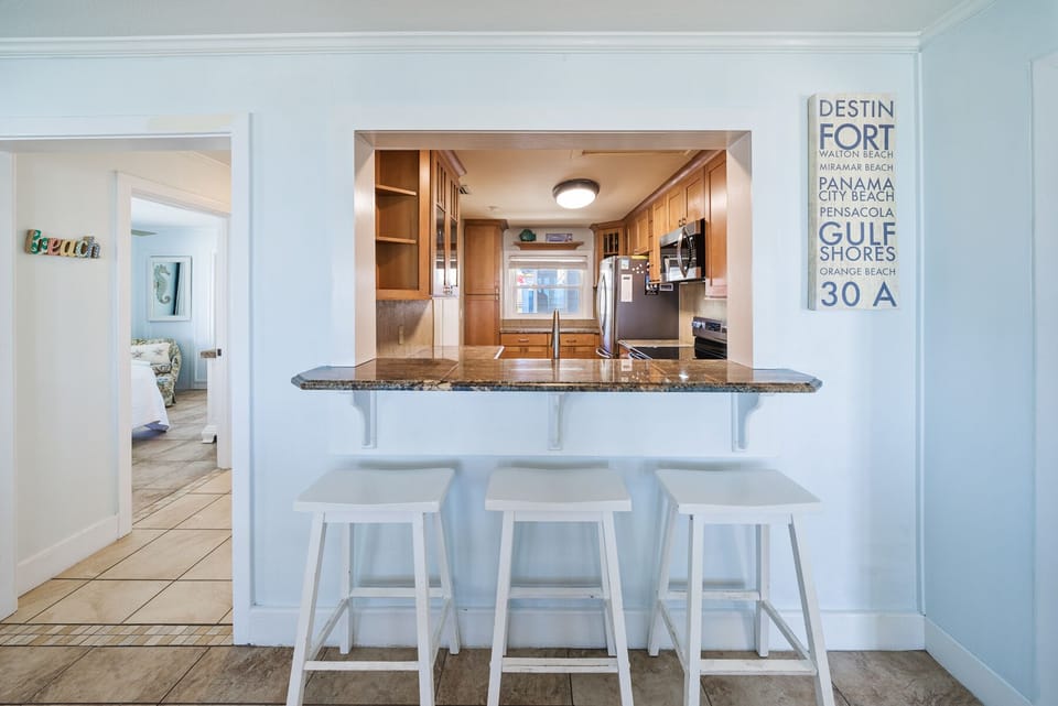 Your beachside kitchen features granite counters and a breakfast bar where you can sip morning coffee while planning your Gulf Coast adventures.