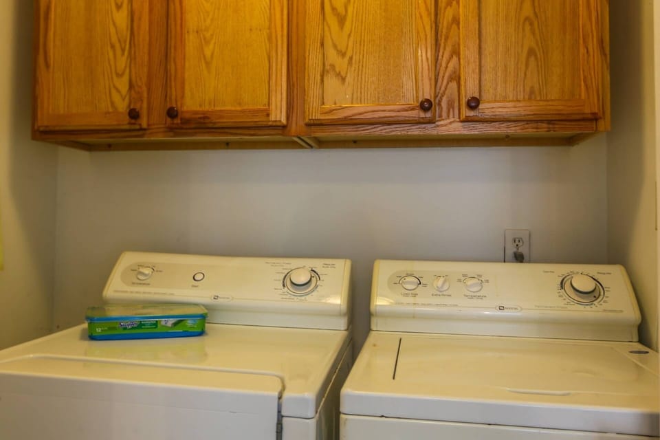 The laundry room has a full sized washing machine and dryer.