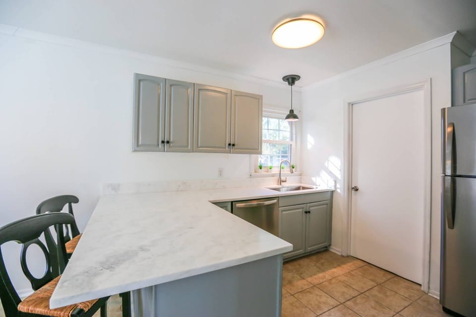 This door in the kitchen takes you to the laundry room and back door to the deck and backyard.