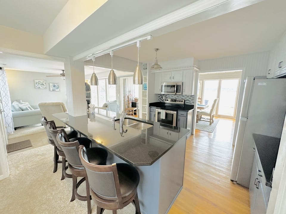 Fully stocked kitchen with bar seating.