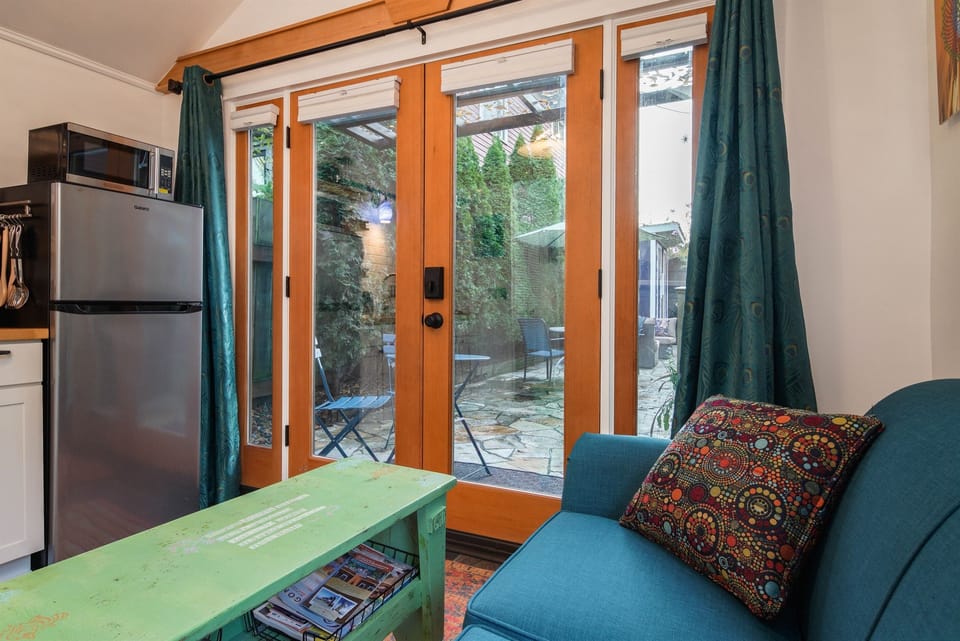 Looking out at the custom-built Douglas Fir French doors. When the sun is out it shines very brightly into the cottage.