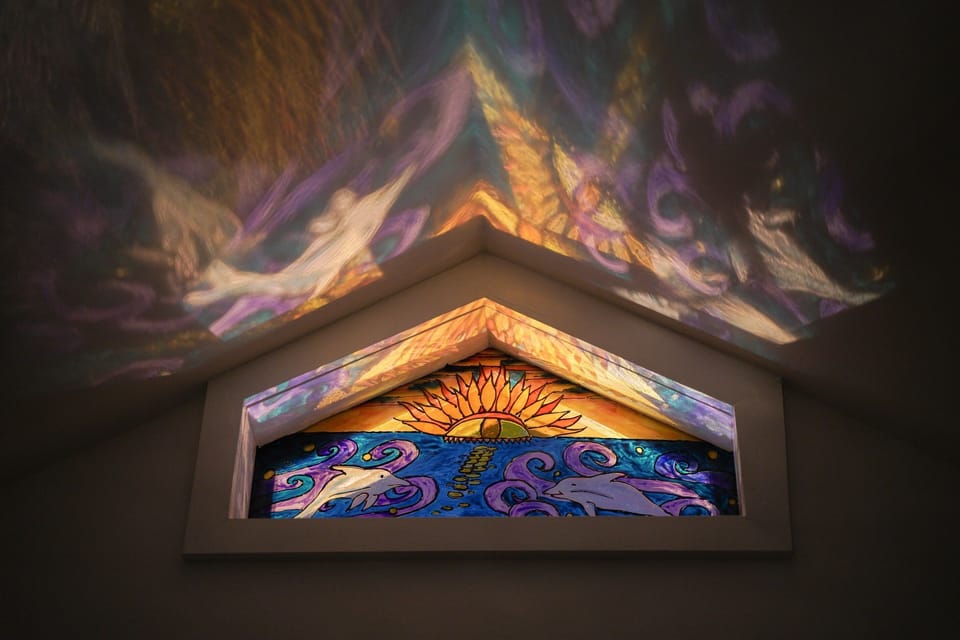 Night light playing through the hand-painted glass window.