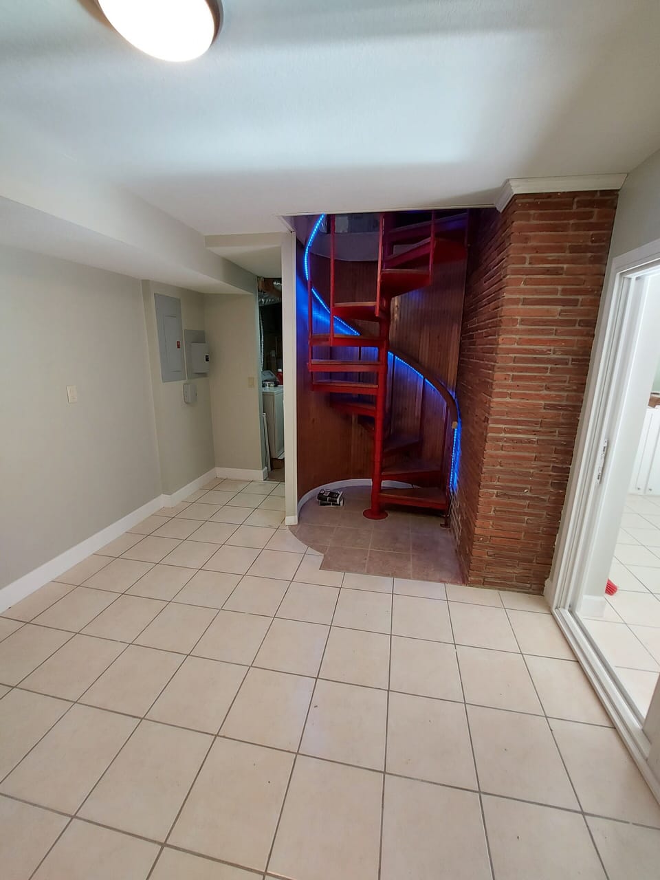 Downstairs room. View of spiral stairs.