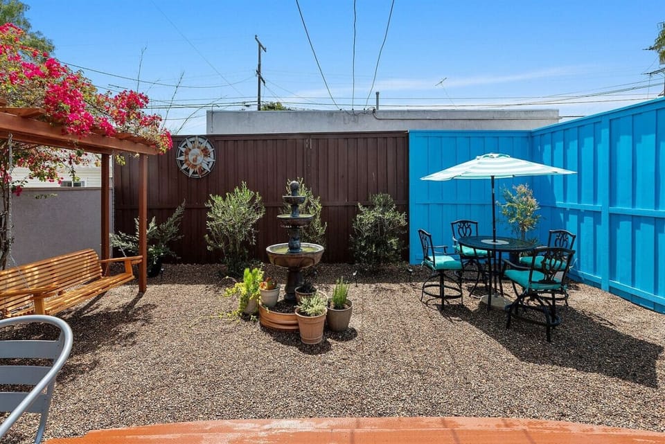 Fountain, plants and patio dining in the pet-friendly private yard