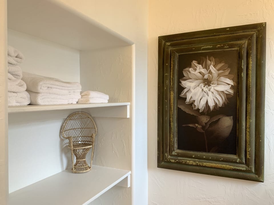 Master bathroom with lots of fresh towels and plenty of shelves for storage