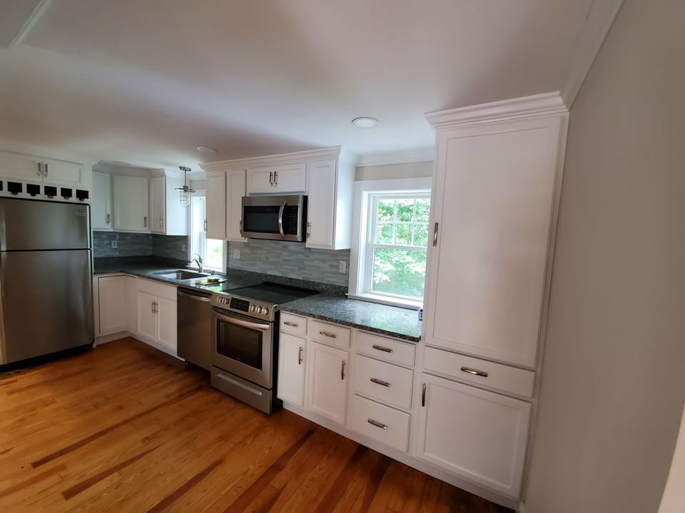 Modern kitchen with all new appliances and fully stocked for cooking.